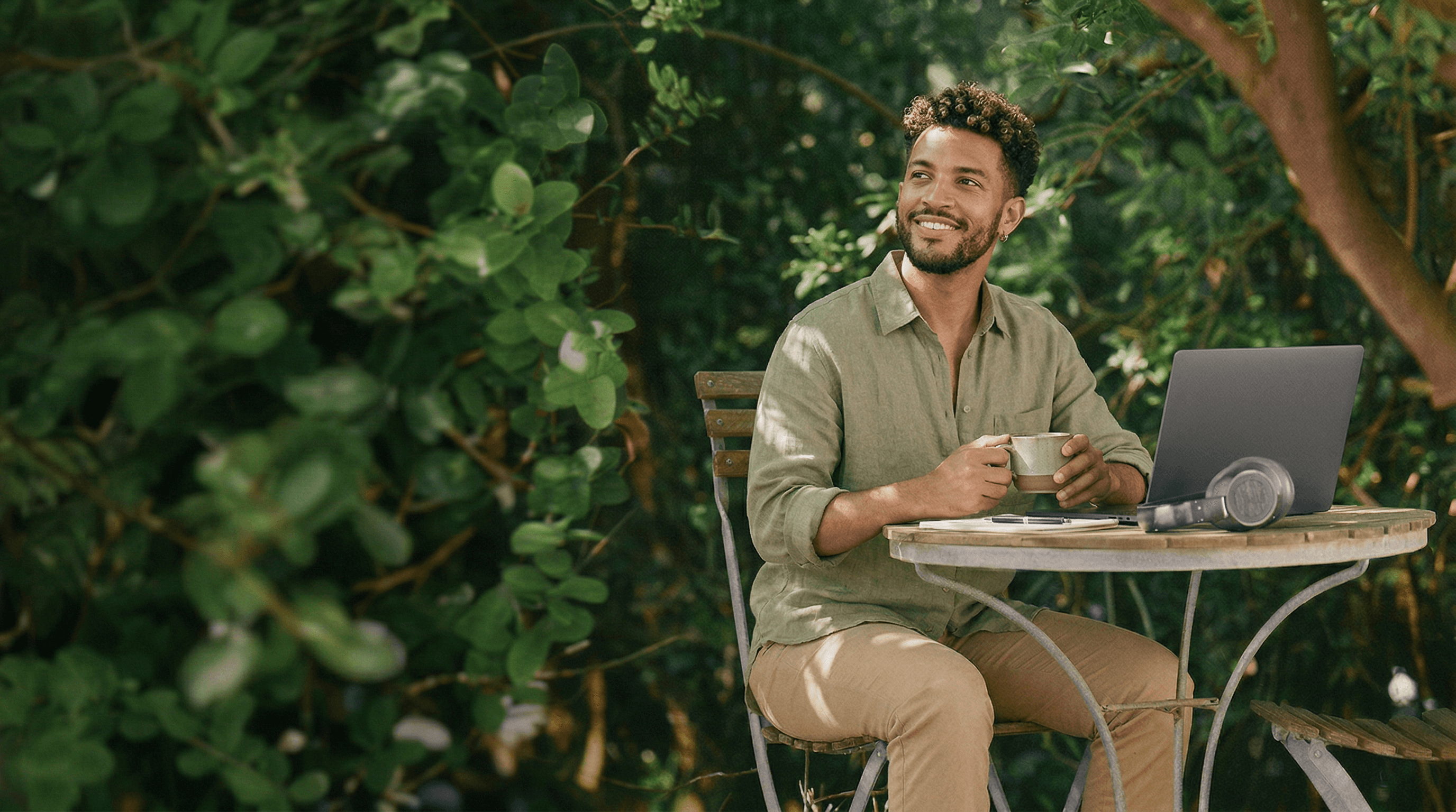 Professional working on laptop outdoors representing AI powered team extension and scalable content production