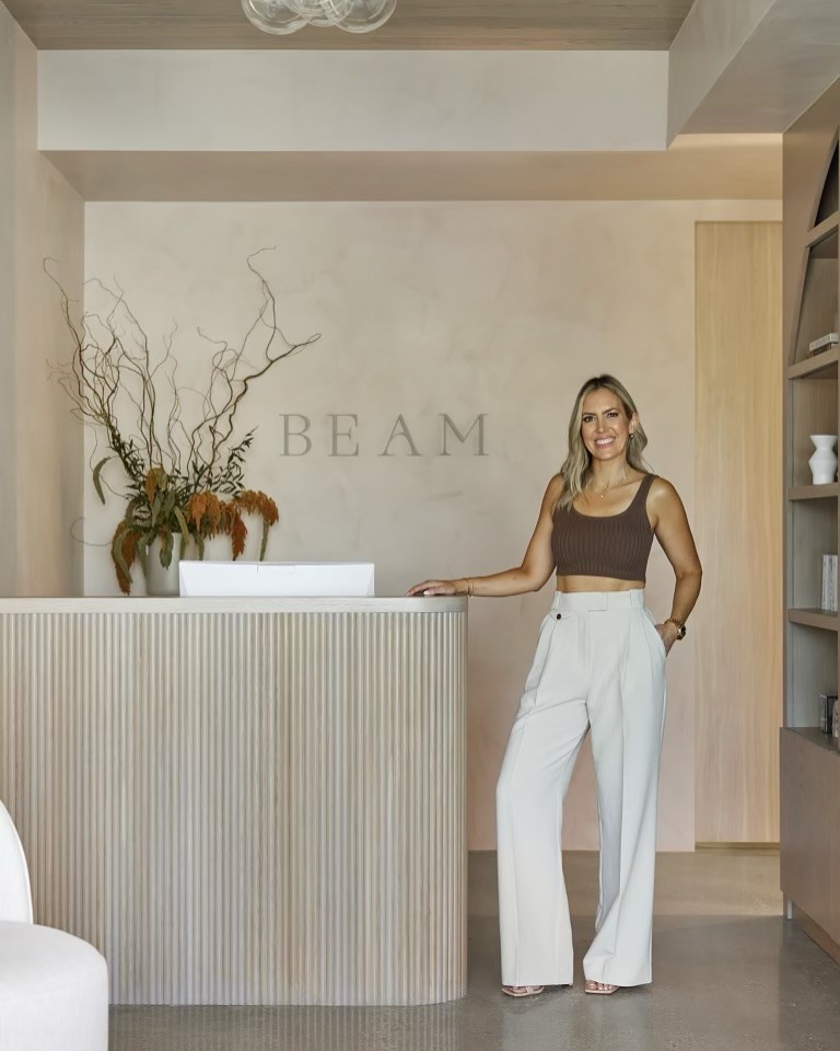 Beam sign with lady standing in front