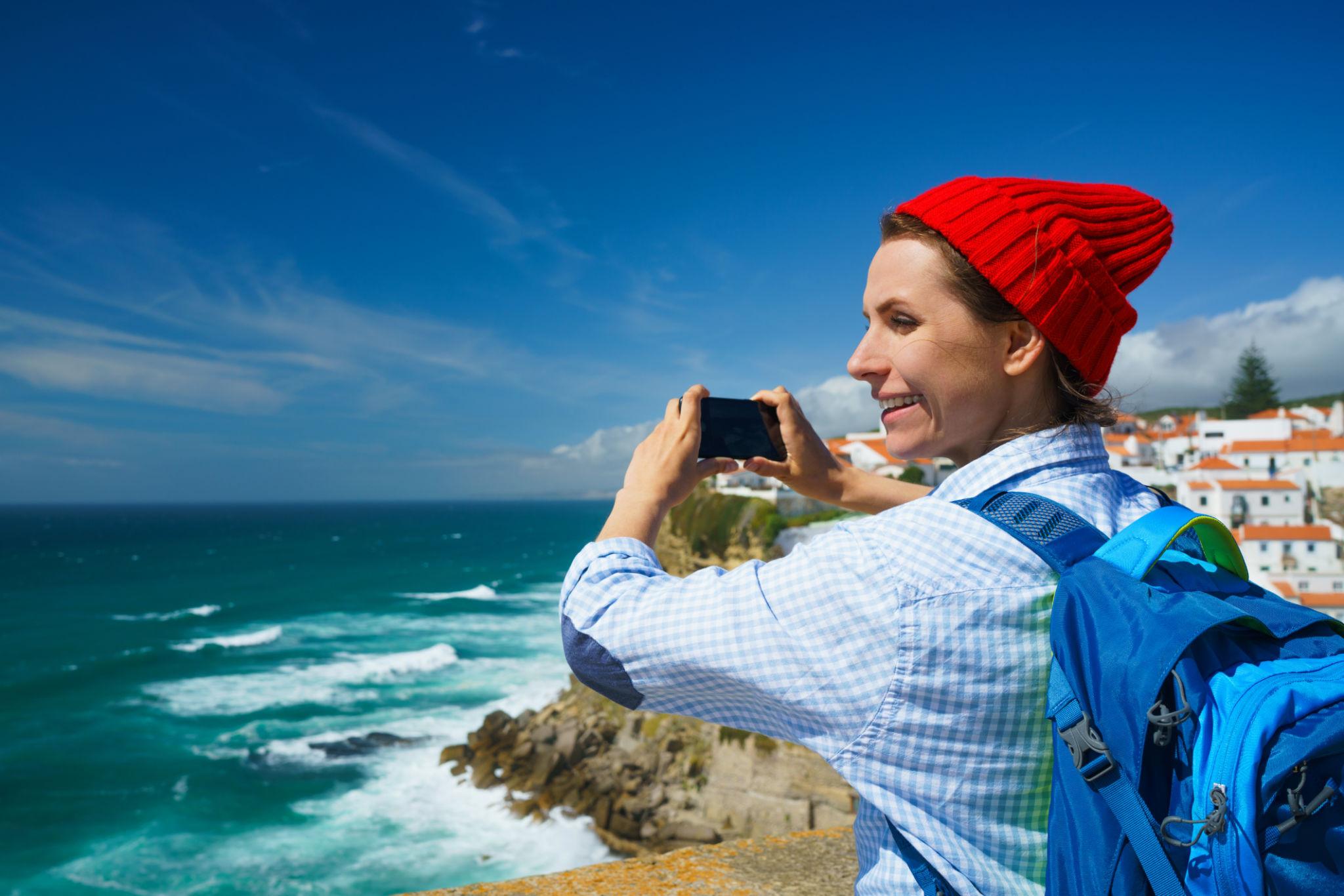 Traveller taking a photo with a smartphone on the Portuguese coast
