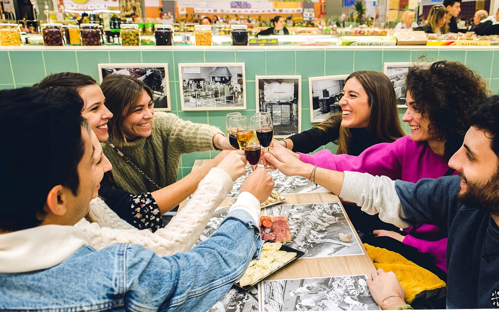 Group toasting with drinks in a Porto tavern.