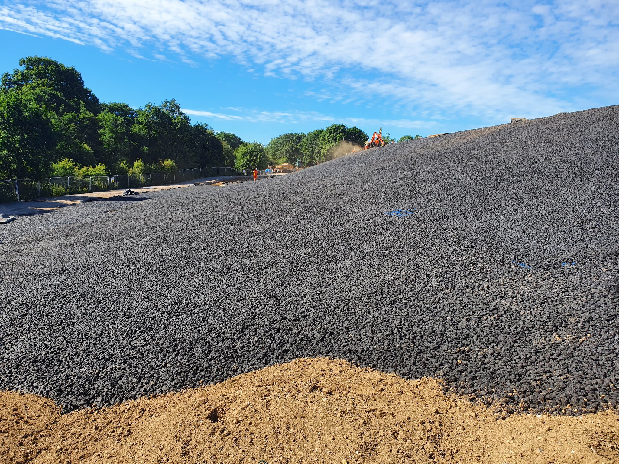 Blurred motion shot of a fast-moving delivery truck passing under a bridge at dusk