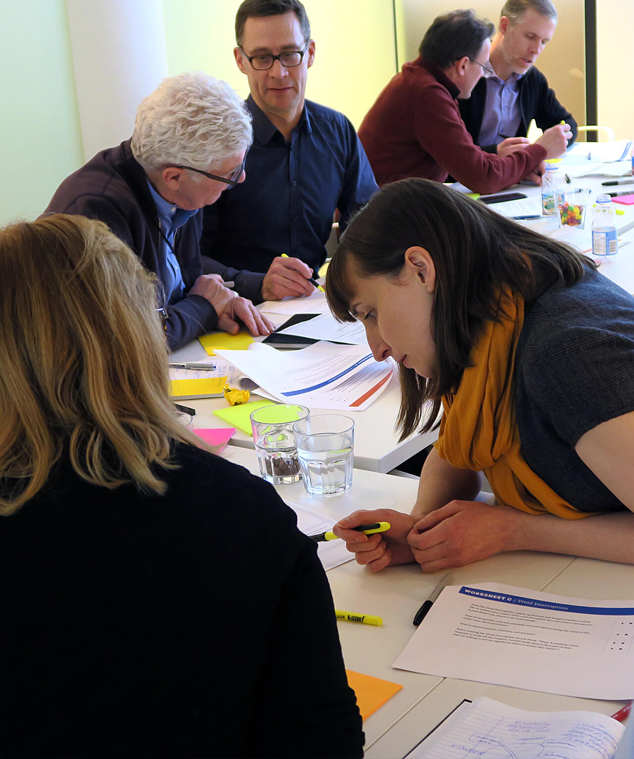 A group of workshop participants reviewing written material.