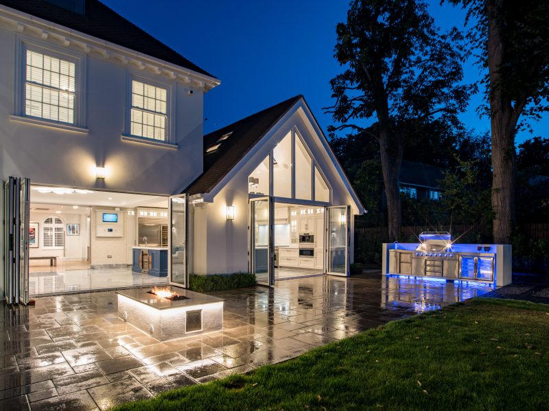 Modern living room with vertical garden, yellow sofas, and stylish coffee tables.