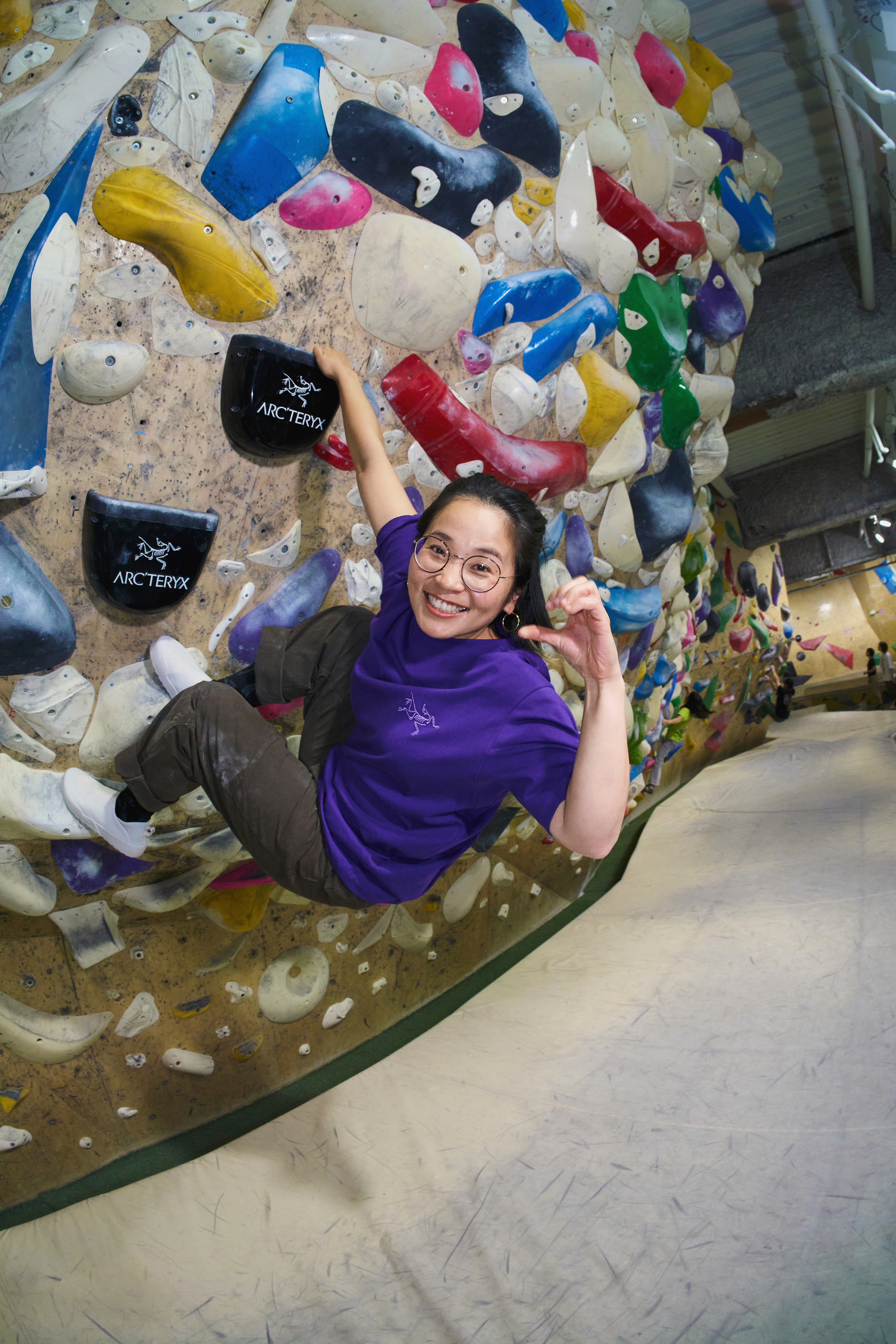 Mei climbing on a rock wall