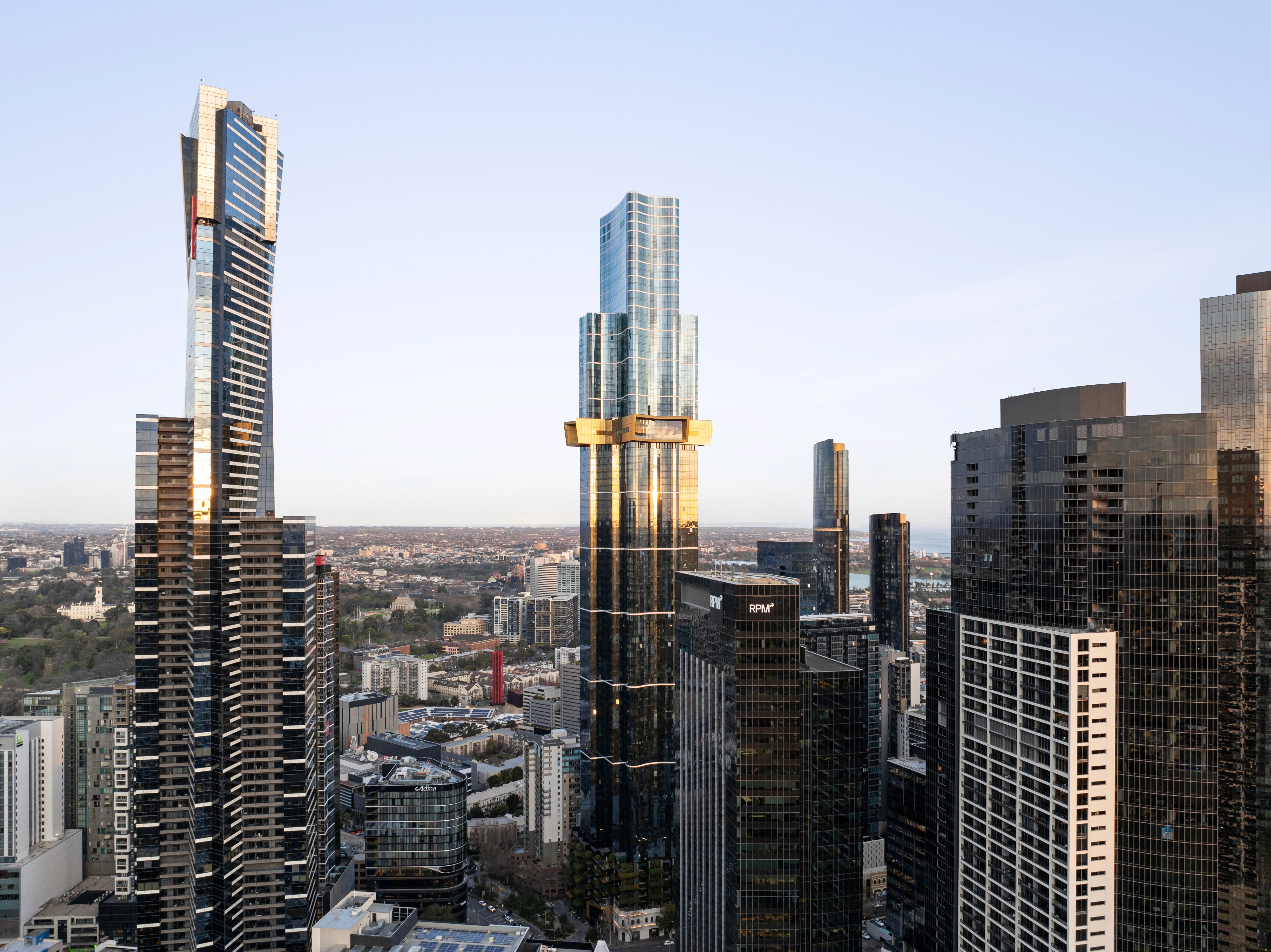 Man on beach with palm trees and mountain