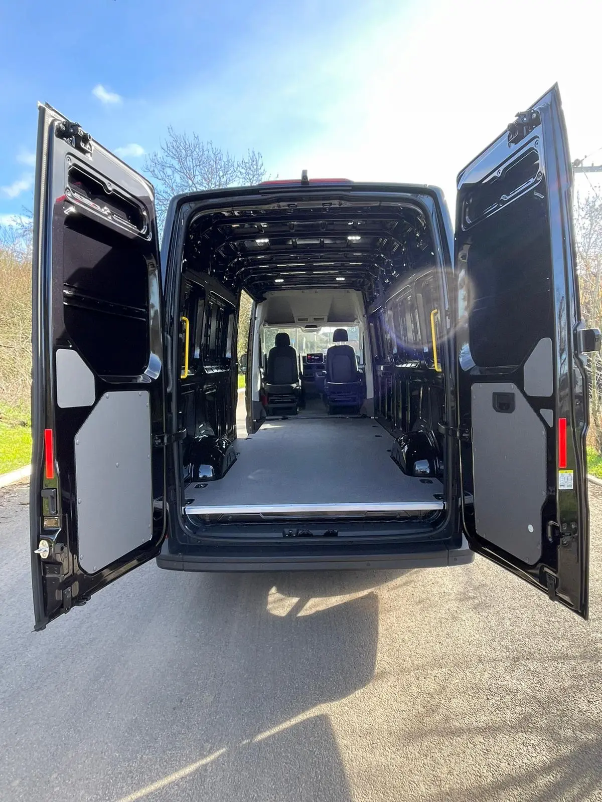 2026 MAN TGE 3.180 4x4 LWB rear three-quarter view with barn doors open, TRU Motorhomes rear plate visible