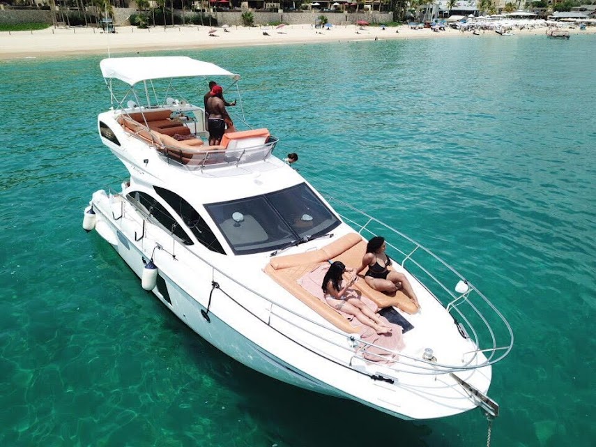 A man stading with Surfboard