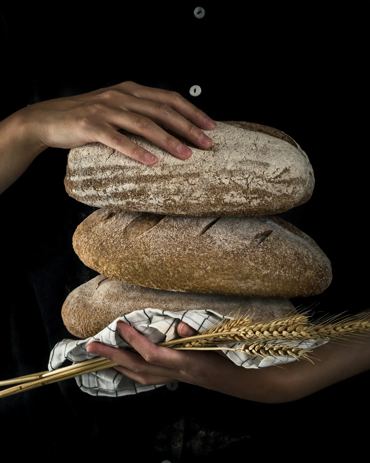 Fresh sourdough bread handed to a customer