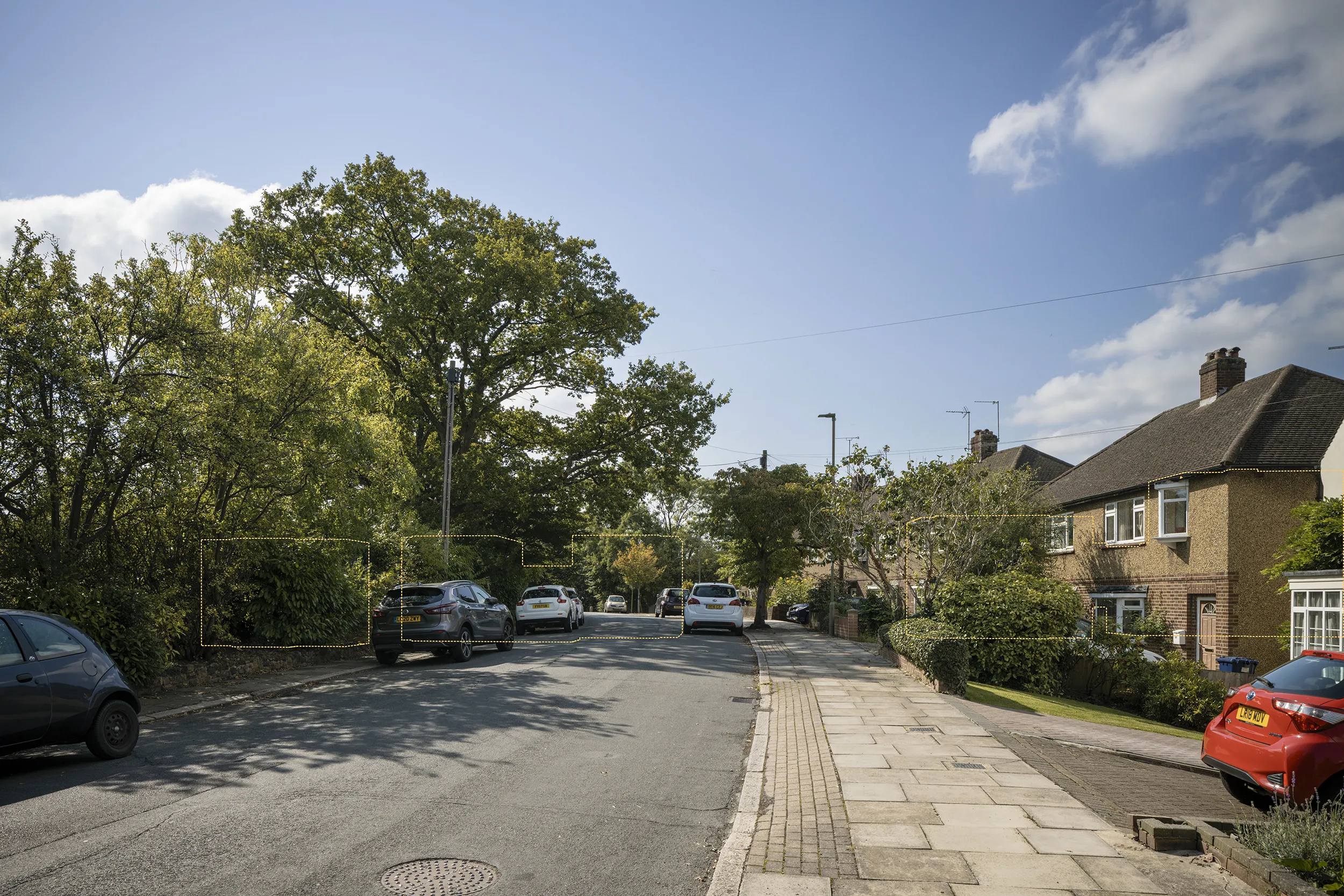 Type 4 AVR Level 1 wireline verified view south west along Potters Lane, with the tops of Buildings C and D behind the trees and vegetation lining the road. Prepared by Eye-kon.