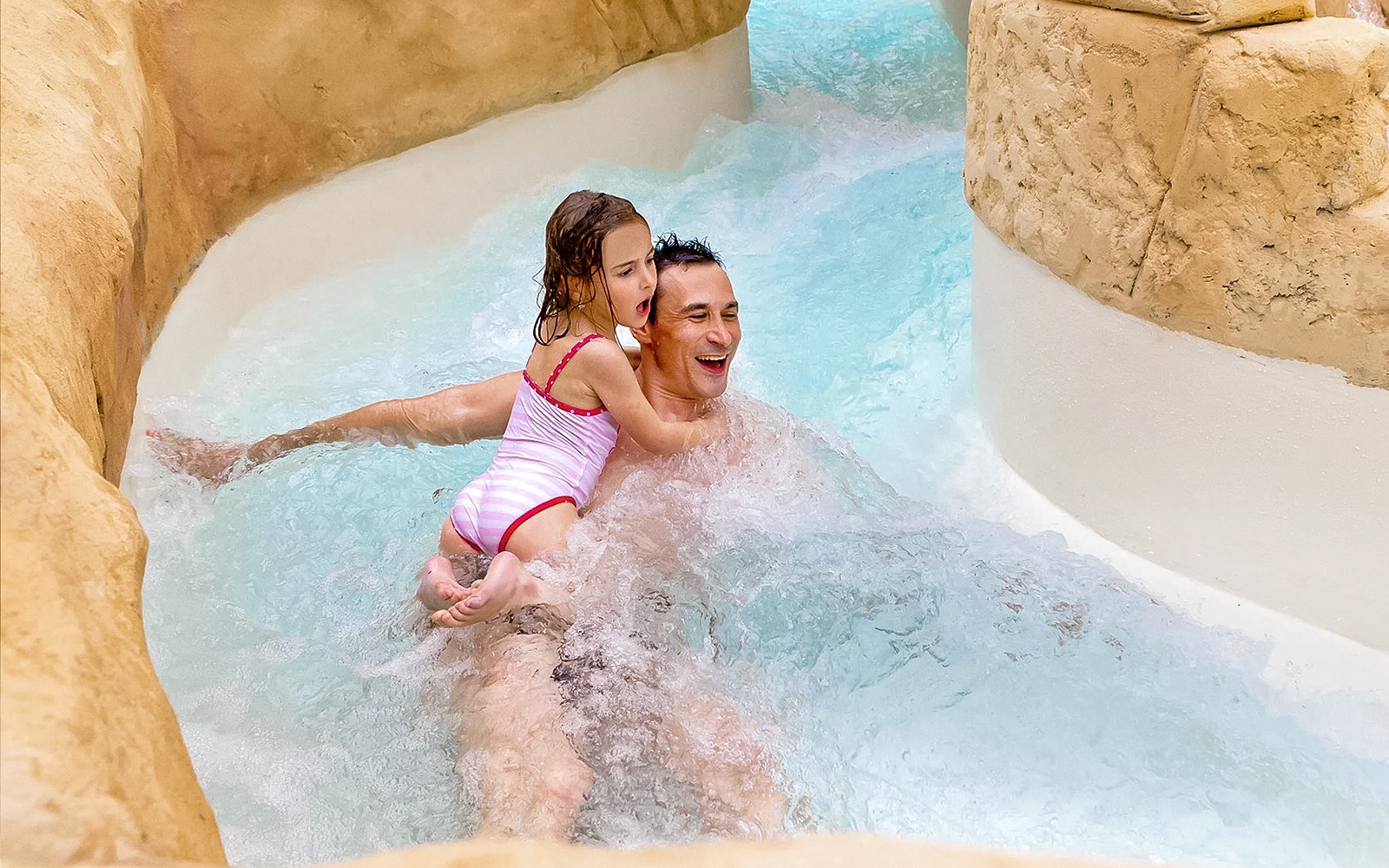Family enjoying the Rapido slide at Aqualibi water park.