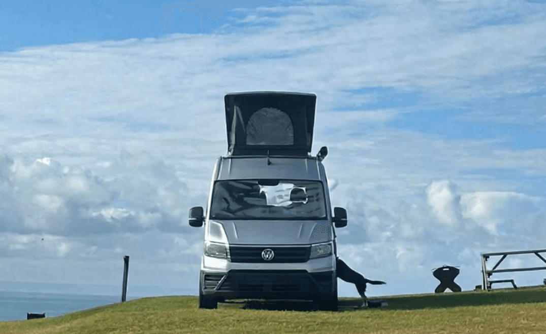 VW campervan with pop up roof on a campsite