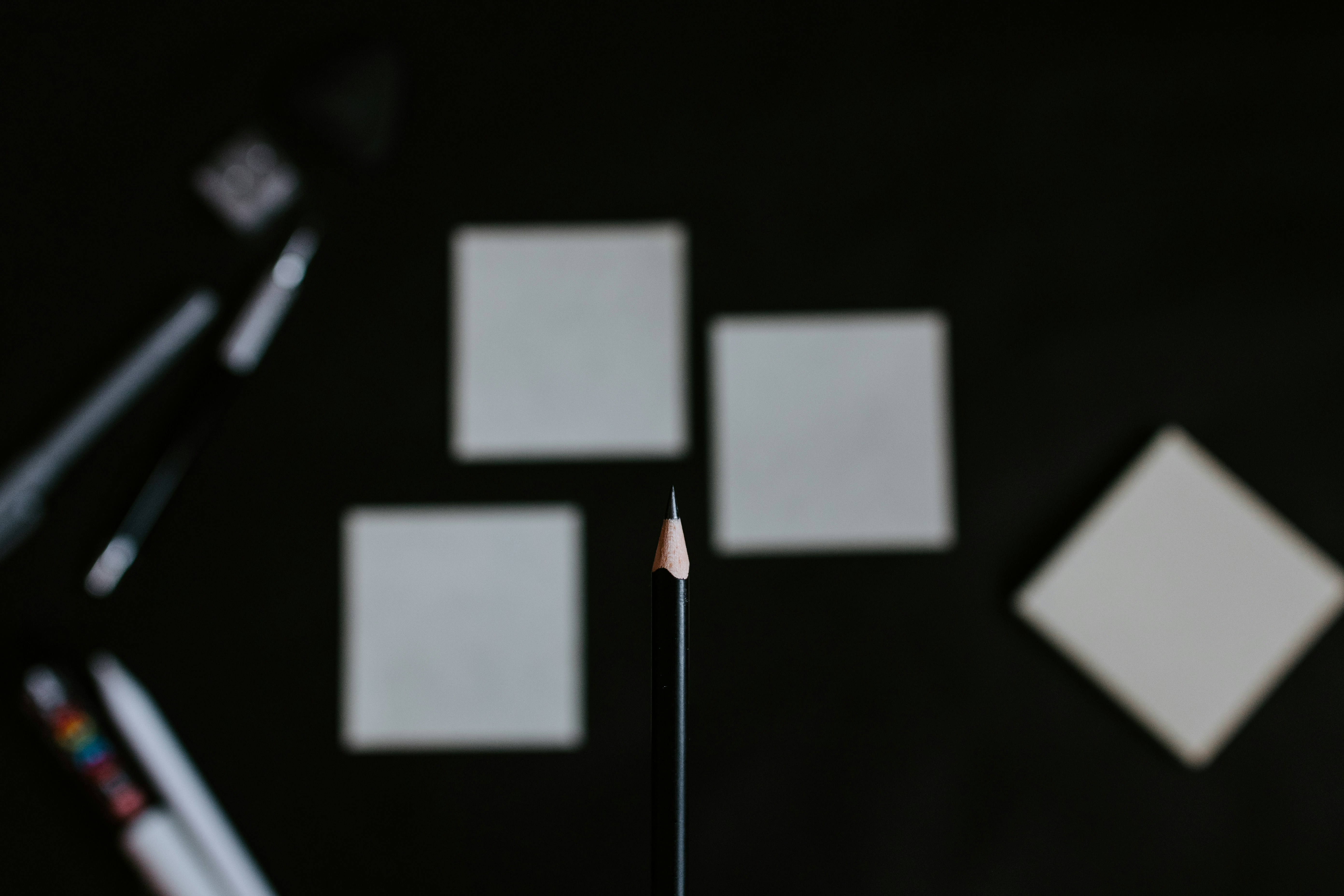 A close up of a pencil and a cell phone