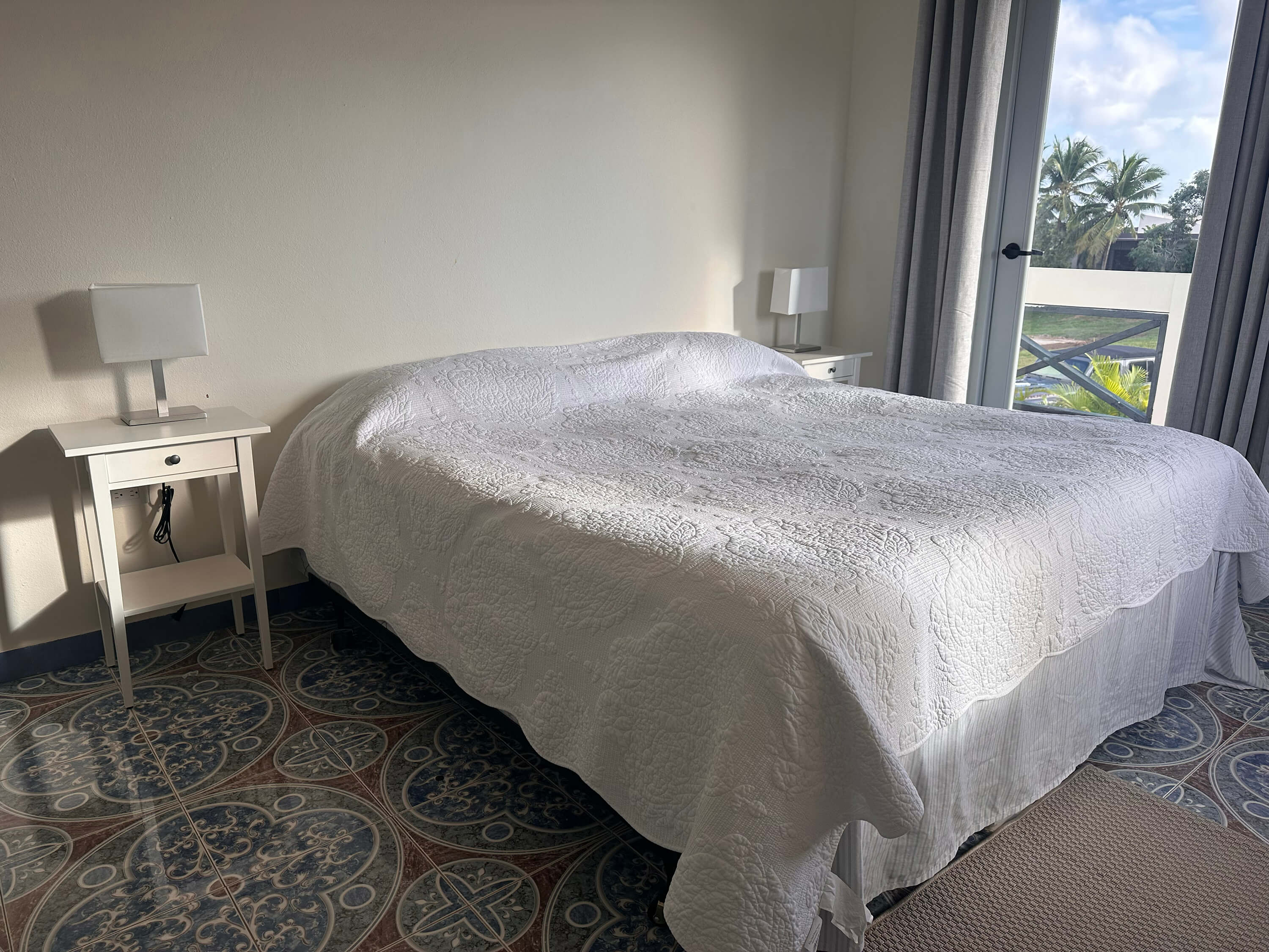 King bed in the spacious interior of Room 6 at Club Vieques, with soft natural lighting, modern decor, and minimalist furnishings.