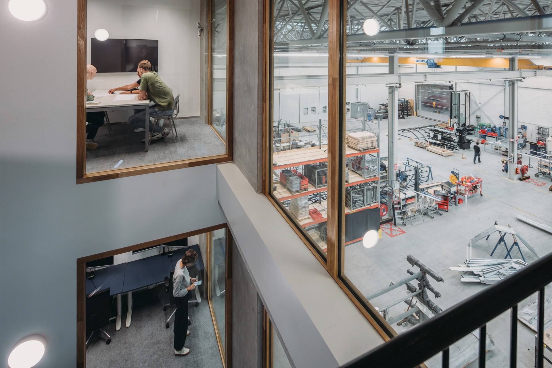 Interior photo of the staircase with views of the office spaces, meeting rooms and production facilities