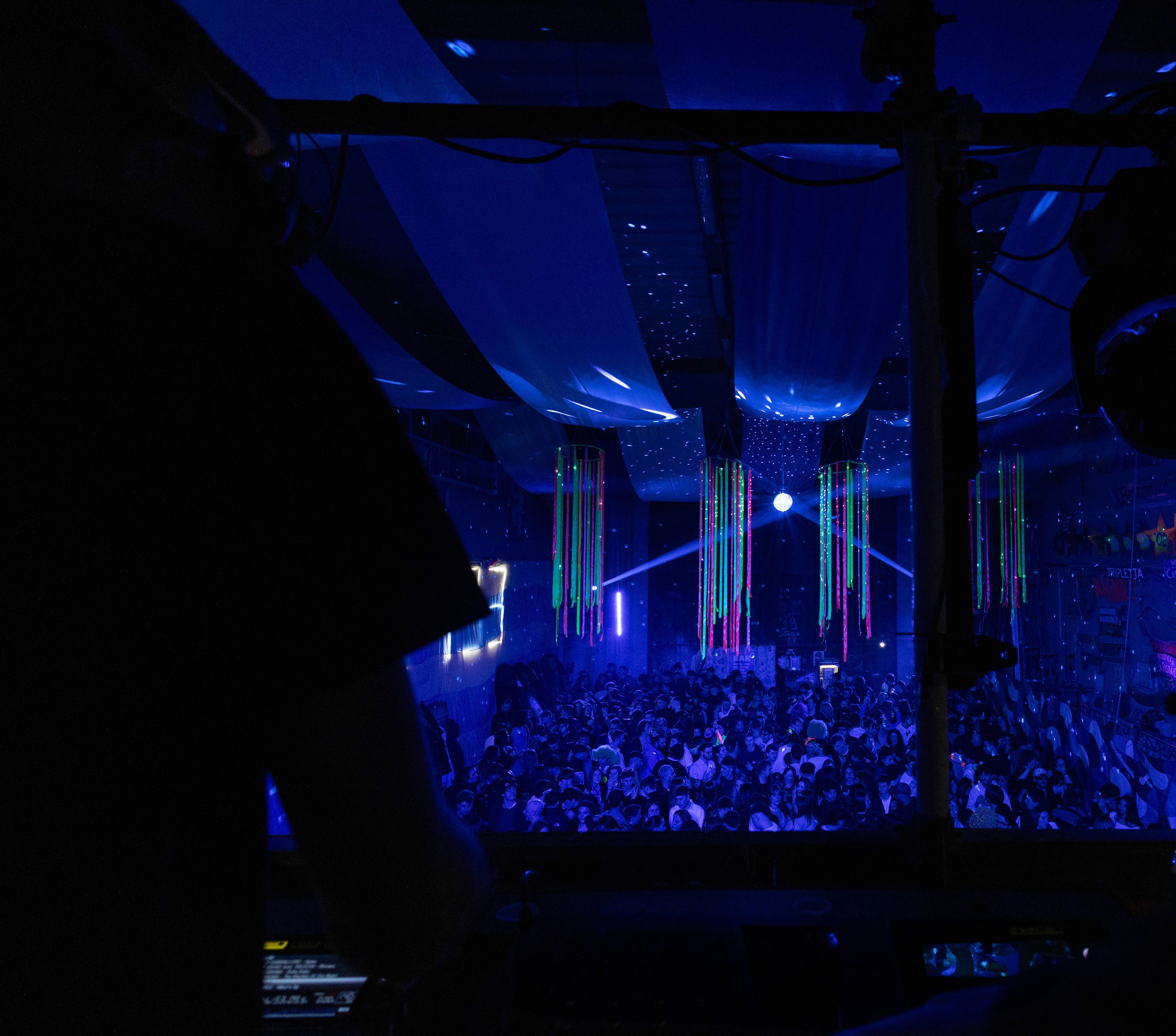 Elf woman in white dress raising hands by the river