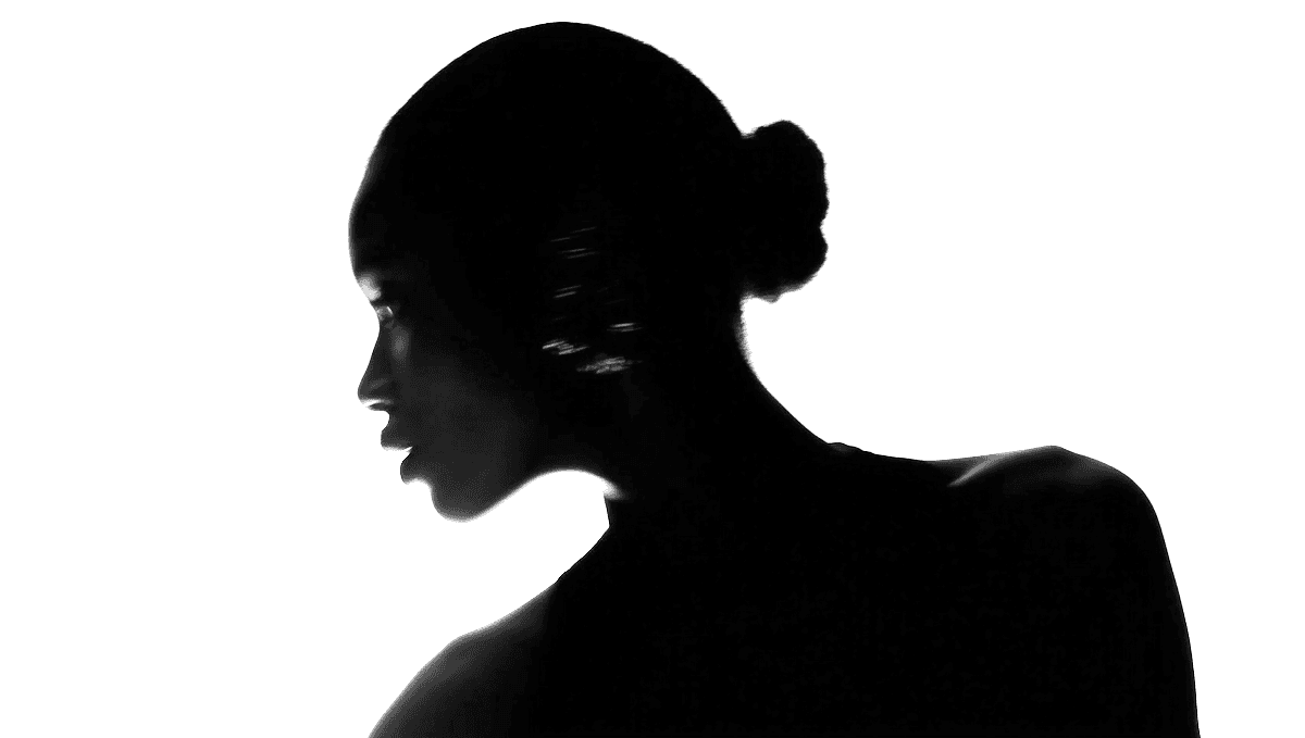 Two men discuss a project while standing at a laptop in an office.