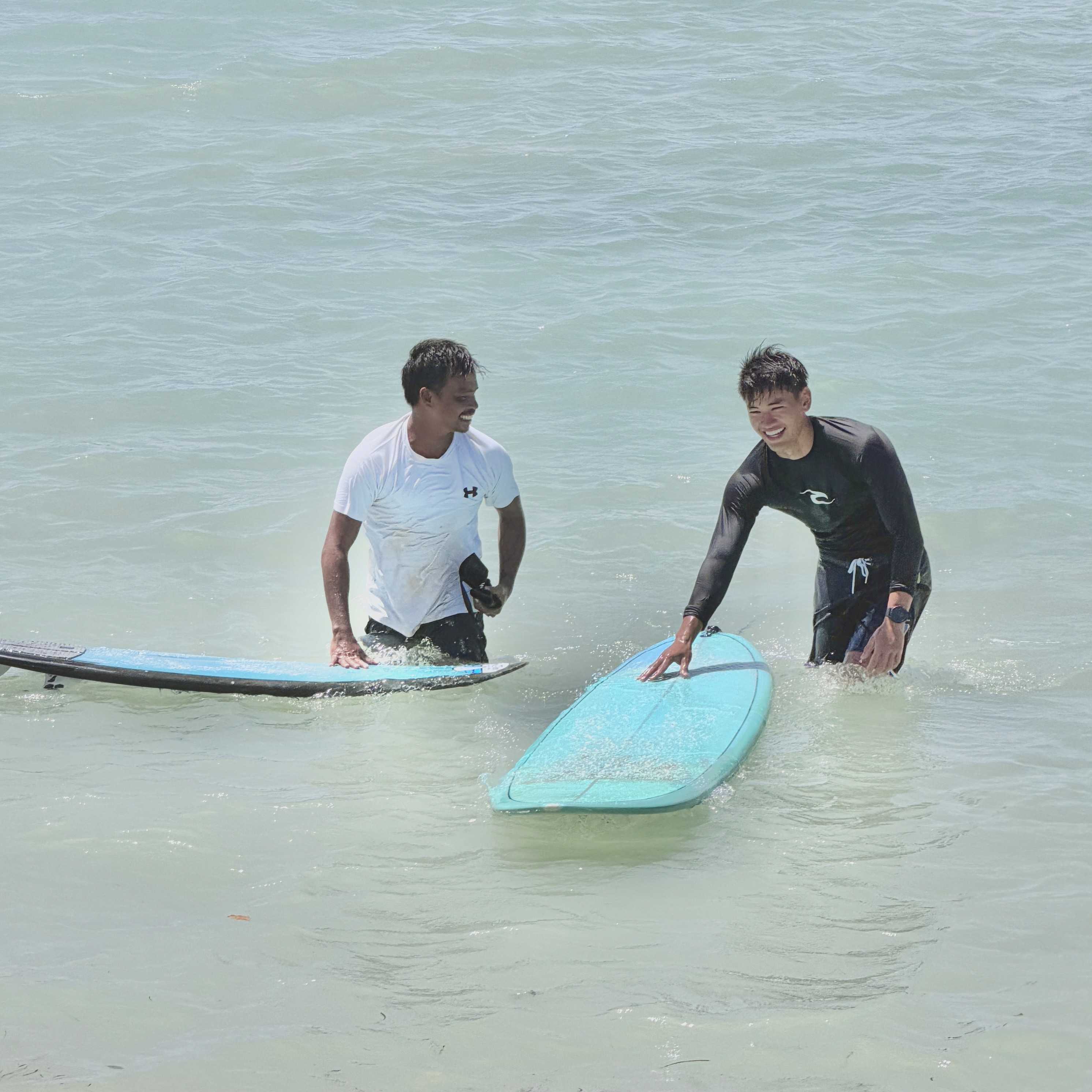Group of men standing with Sufboard