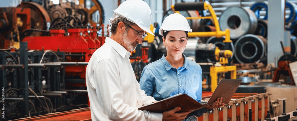 Two machine workers evaluating results