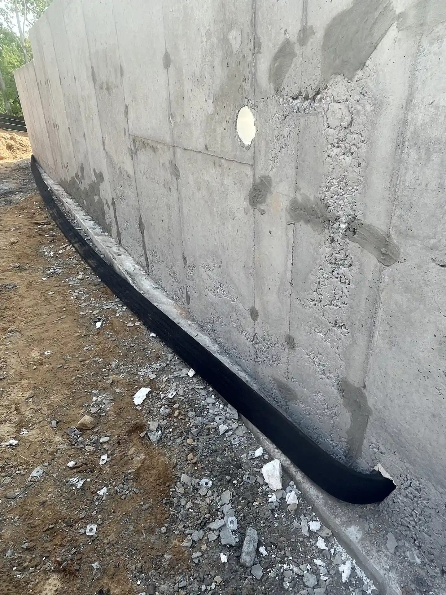 Strip drain at the base of a foundation