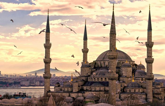 Baking at sunset. Hands press dough on floured board, dust rising. Golden light streams through window.