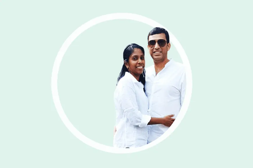 Couple in white shirts smiling inside a circle frame.