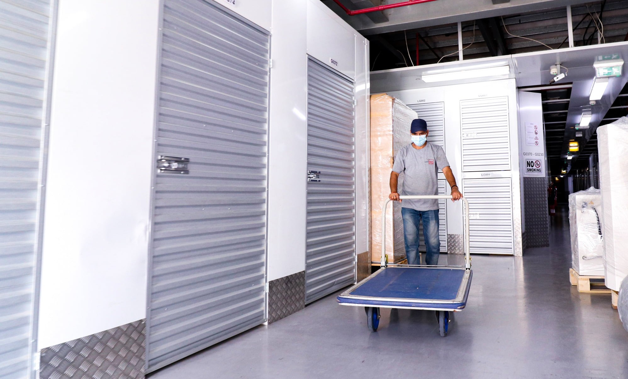 Spacious commercial storage unit with a man working inside