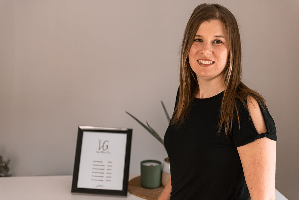 headshot of Laura Green wearing a black top smiling against a neutral background
