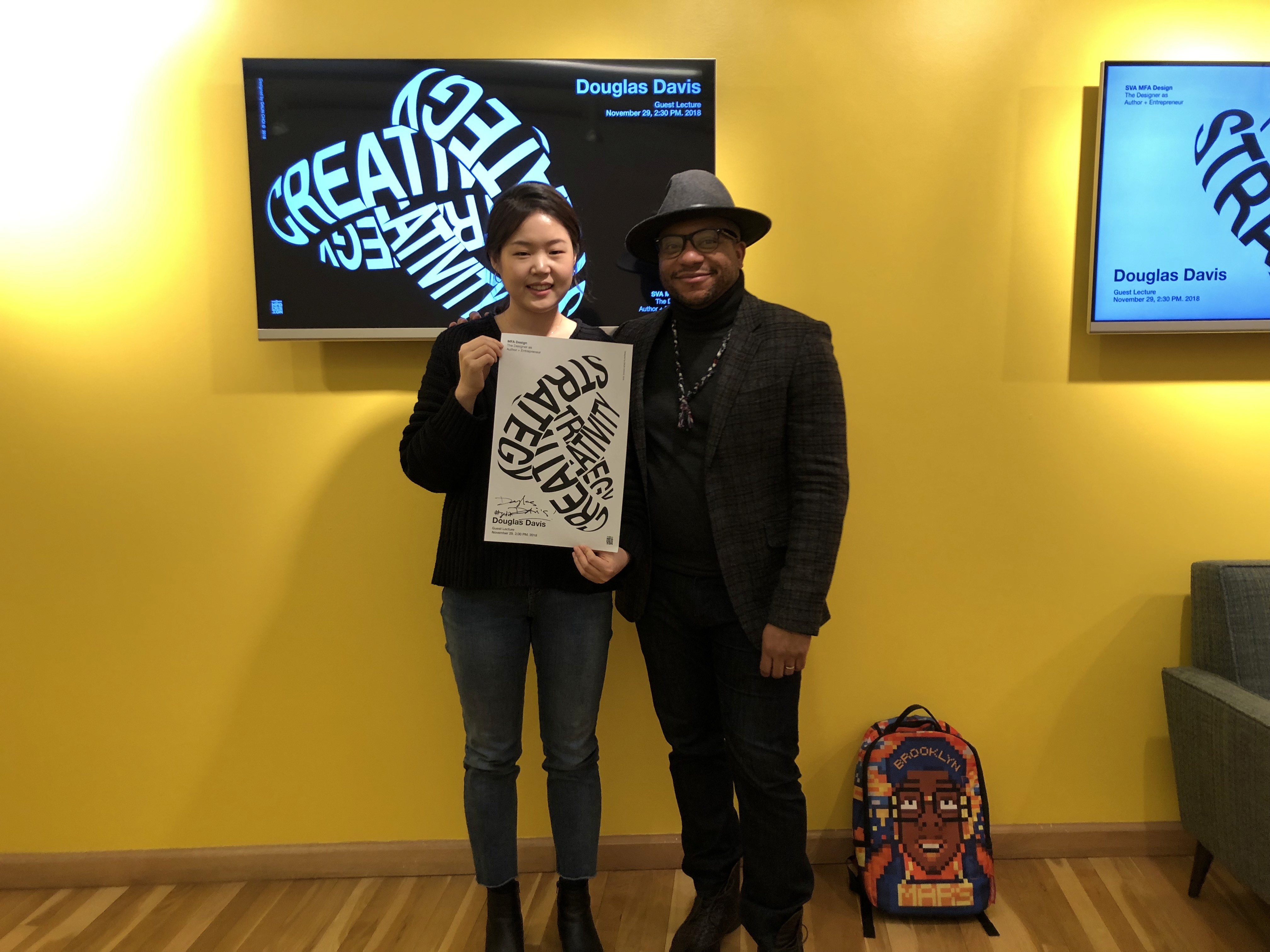 Douglas Davis with a student holding poster