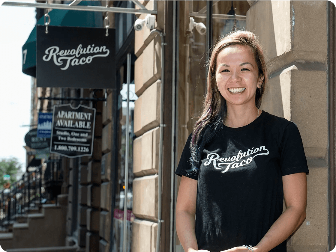 Carolyn standing in front of Revolution Taco