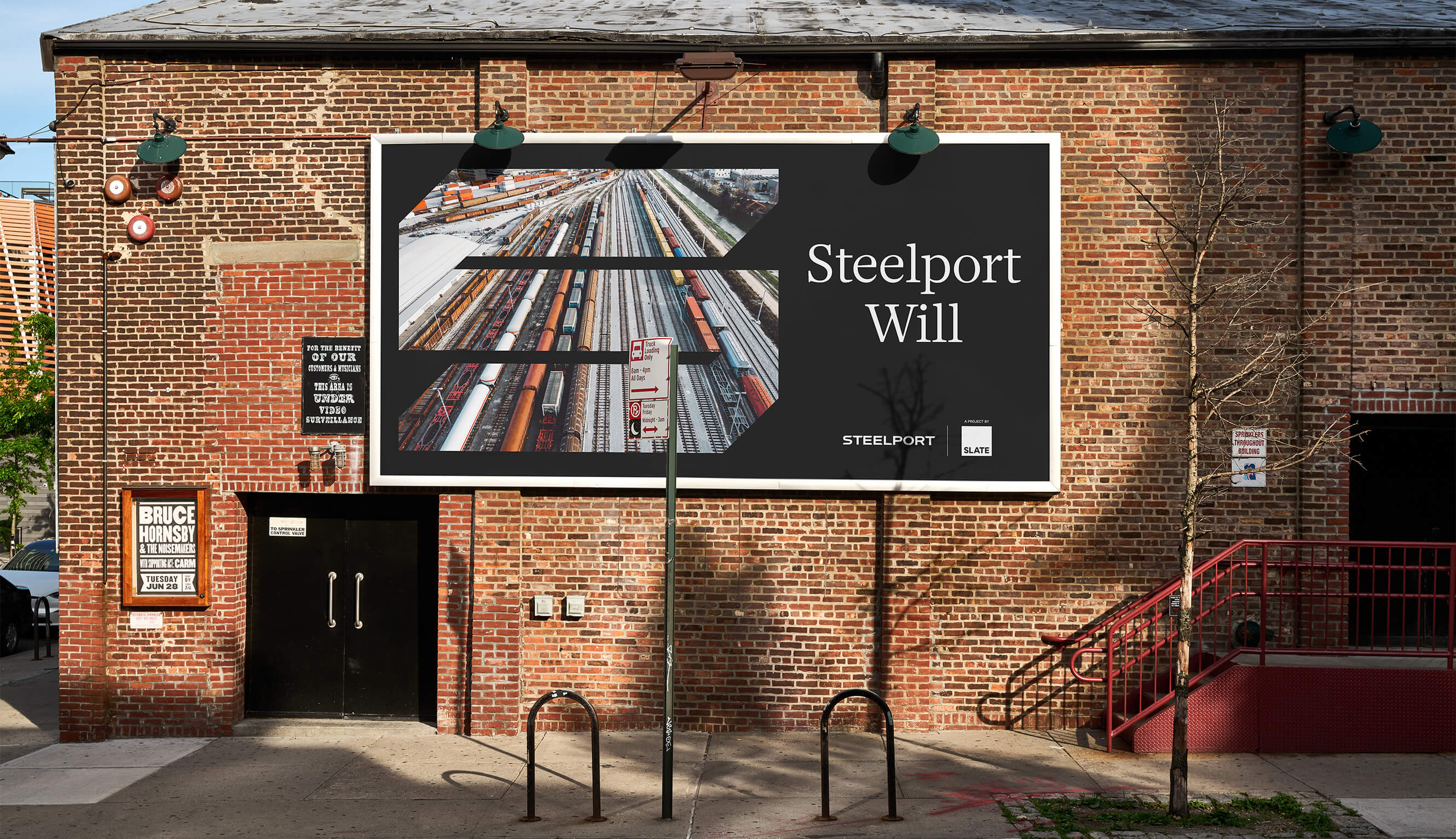 A billboard with the Steelport logo framing an aerial shot of a rail yard, with text that reads "Steelport Will."