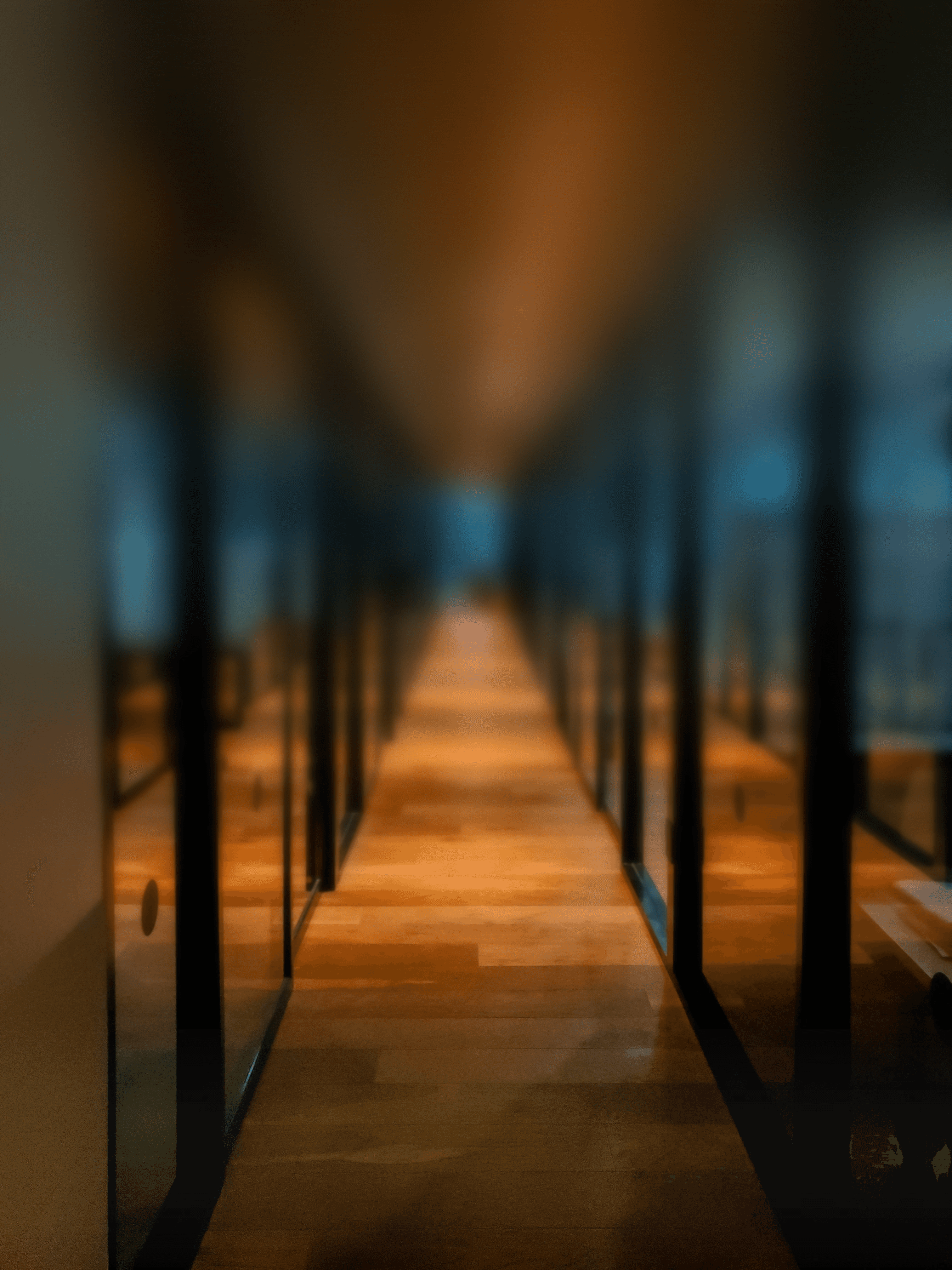 glass paneled long wooden floored hallway