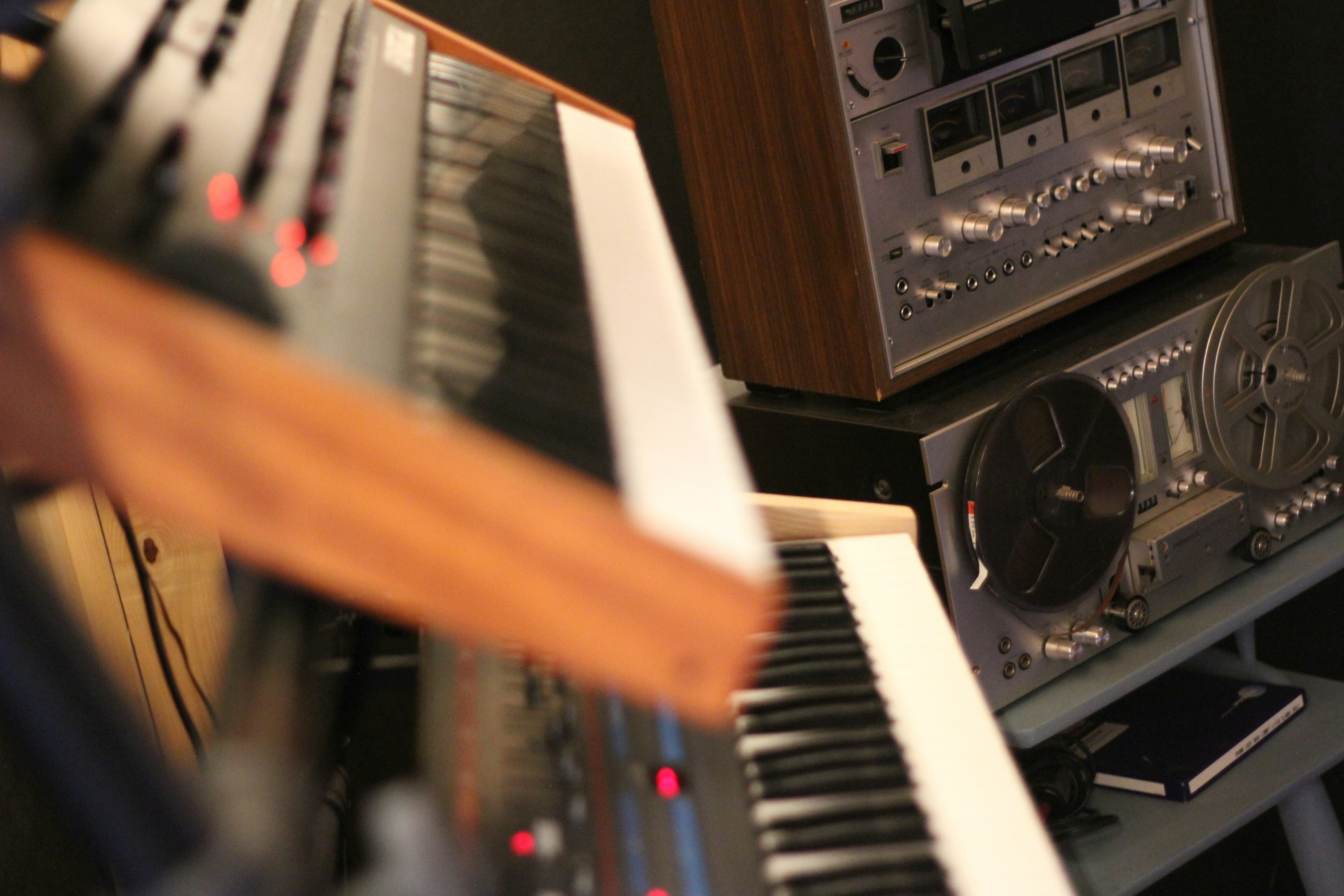 Vintage audio equipment and synthesizers in studio. Photo by Coppa Cover on Unsplash