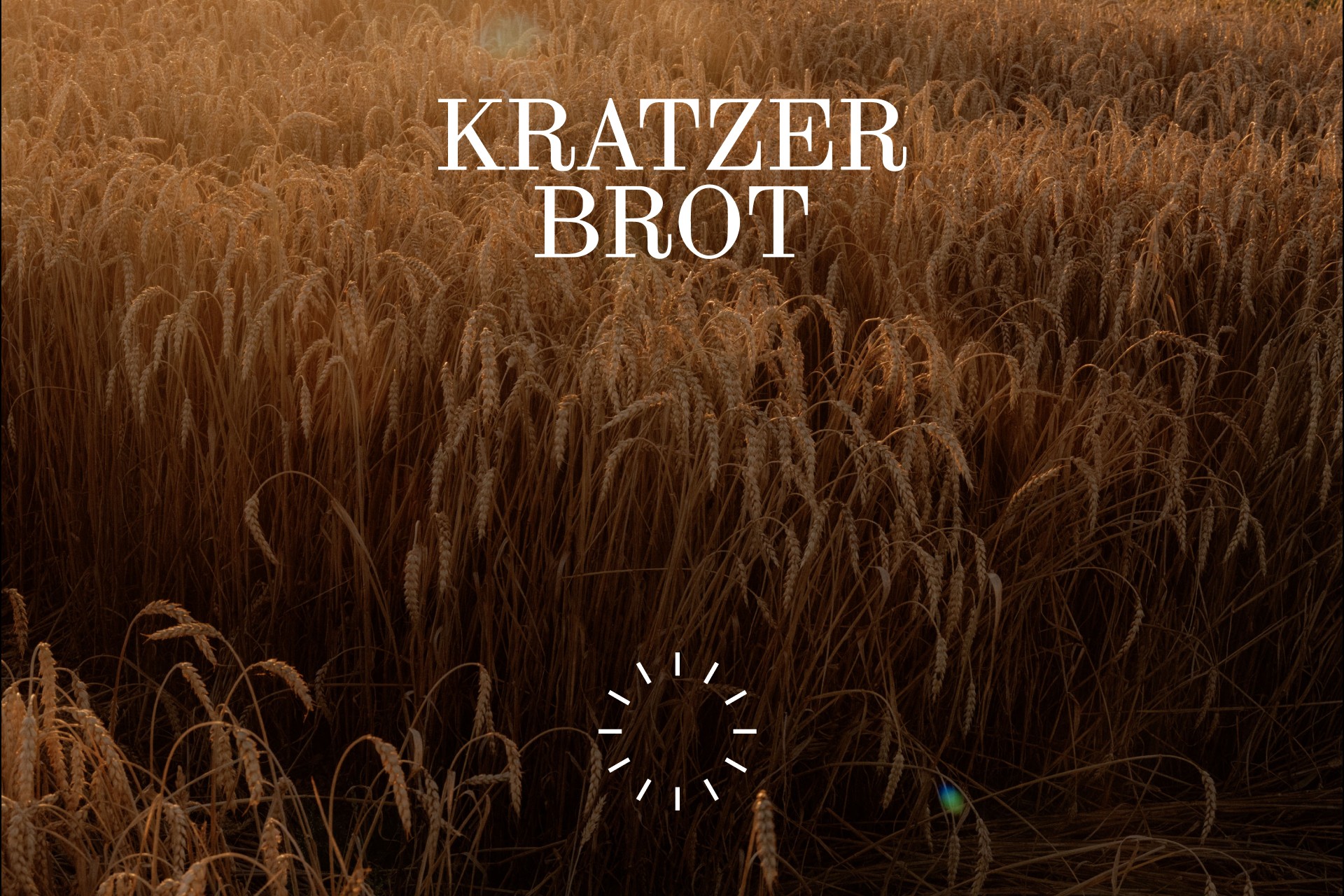 A picture of a wheat field in the back with the Kratzer Brot logo and wordmark on top of it. 