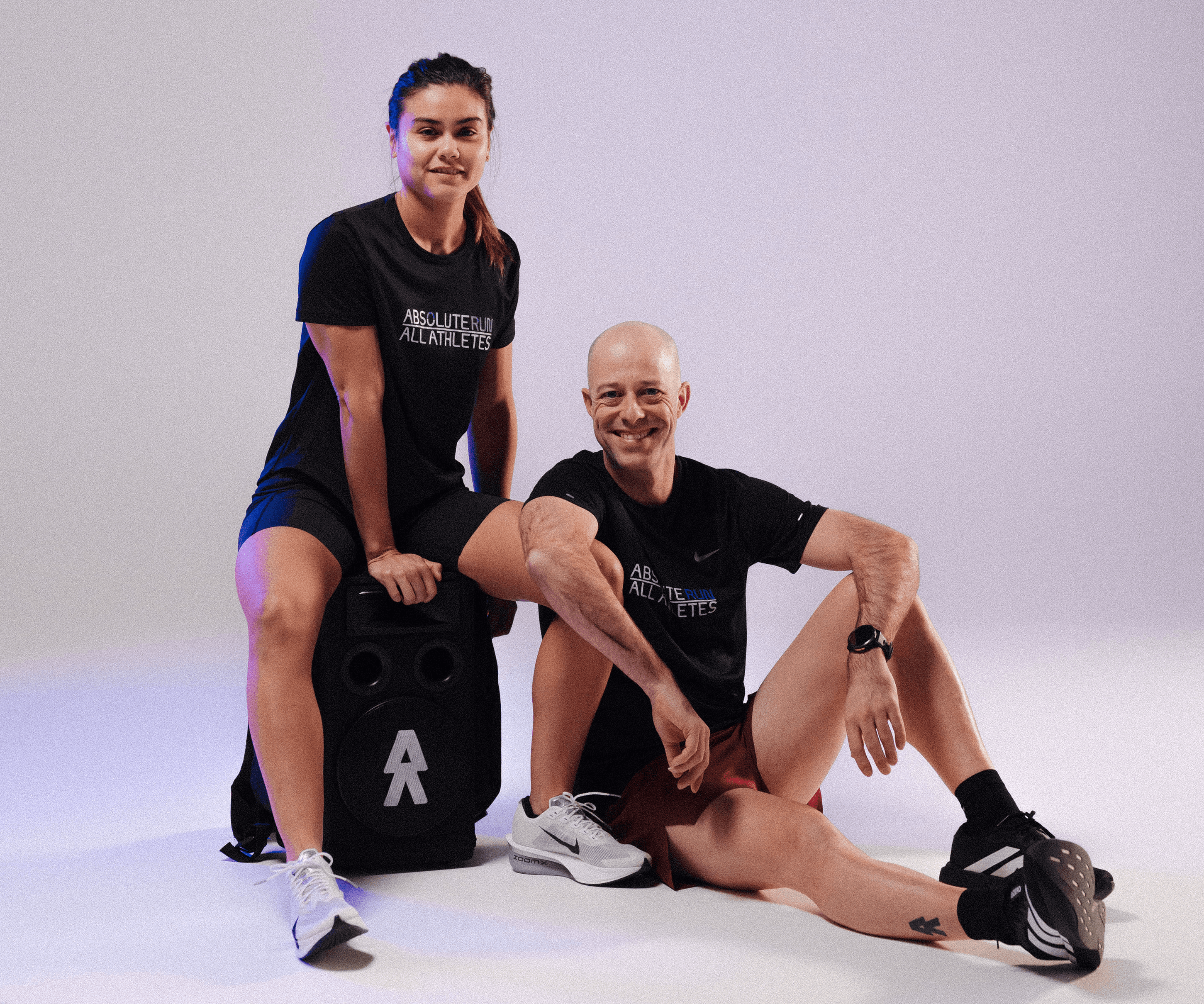 Black and white image of people working at a table with laptops, showing hands gesturing during discussion of digital content displayed on screens, with fabrica® logo in the corner.