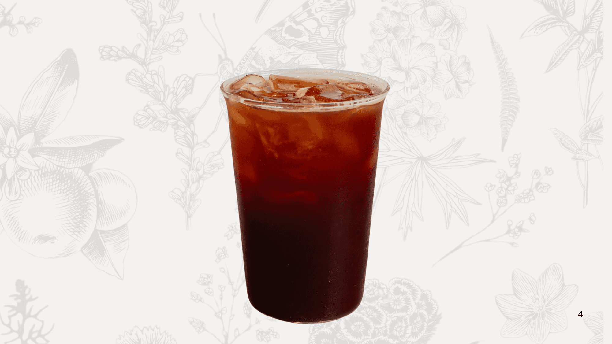 Iced matcha with orange juice in a clear cup, topped with a lemon slice