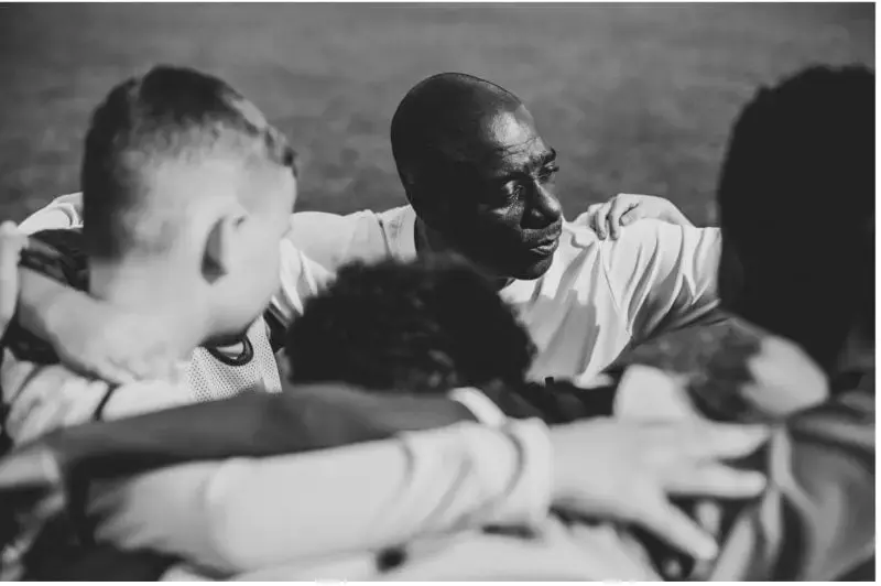 Soccer team hugging, motivating each other