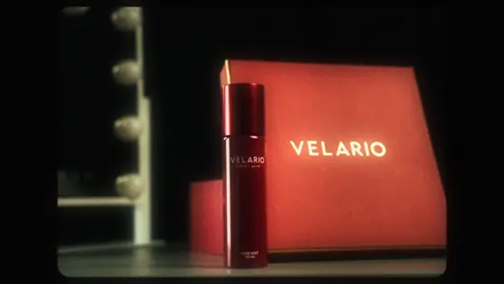 A red Velario bottle in front of its red Velario box, from the Velario brand film by Thundrk Studio