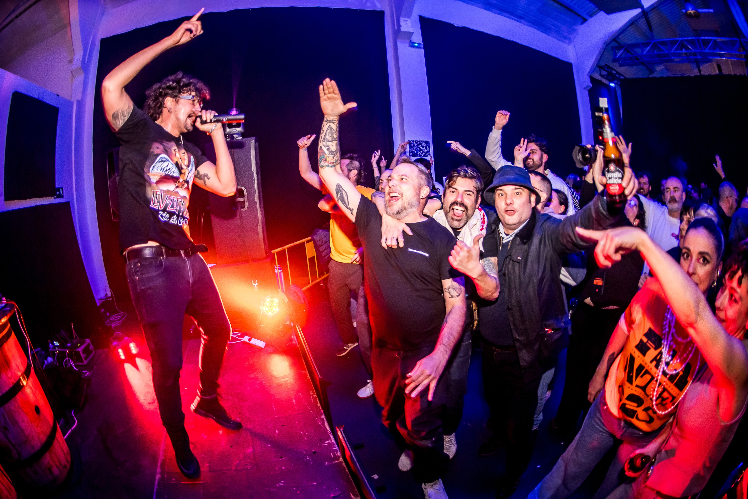 Young leady in green sweater asks a question into a conference mic.