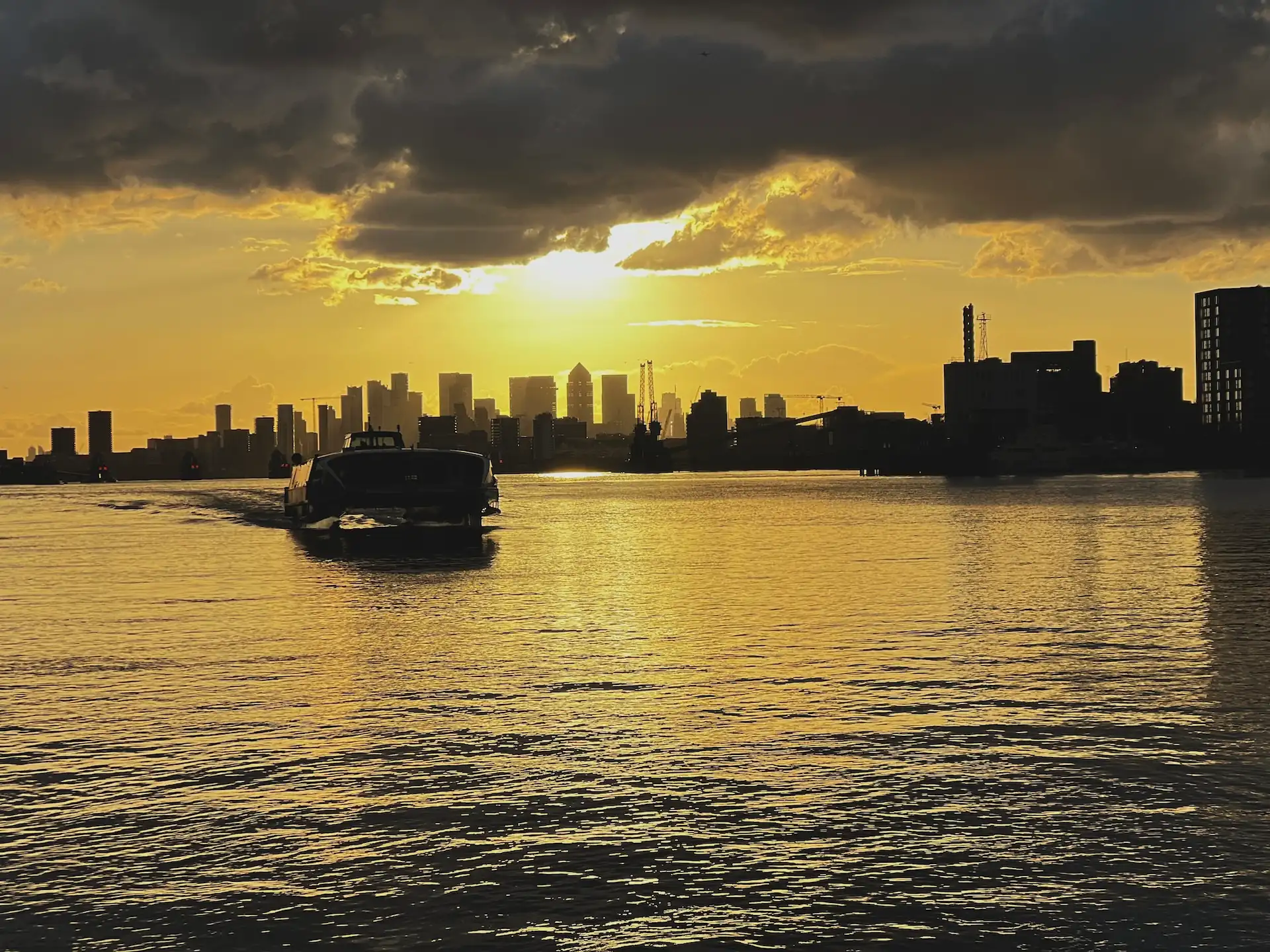 A scenic wide view of the River Thames at Woolwich Arsenal Pier and Uber Boat terminal, located just a 3-minute walk from the Creative Kin video podcast studio in London SE18.