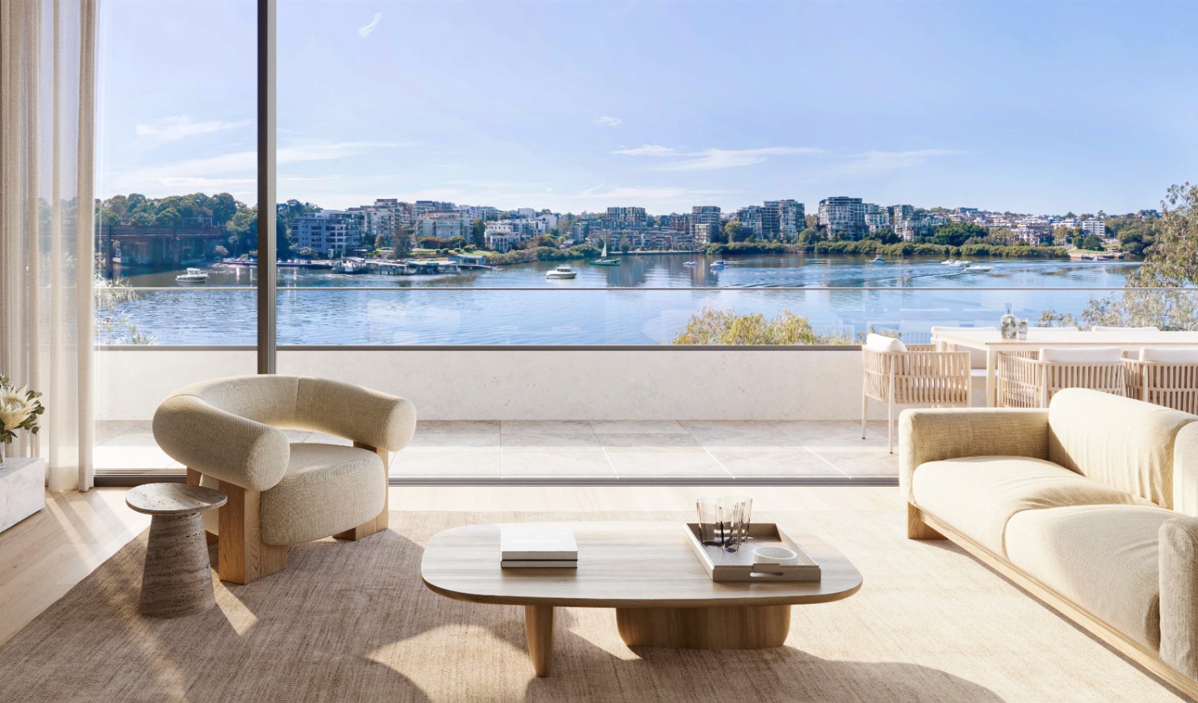 Bright open-plan living room at Rhodes Bay featuring floor-to-ceiling windows, natural finishes, and uninterrupted waterfront views.