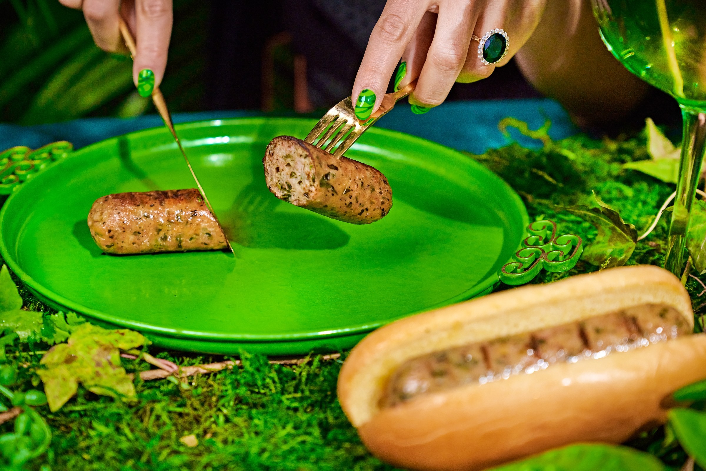 Salsa Verde sausage on a bright green plate