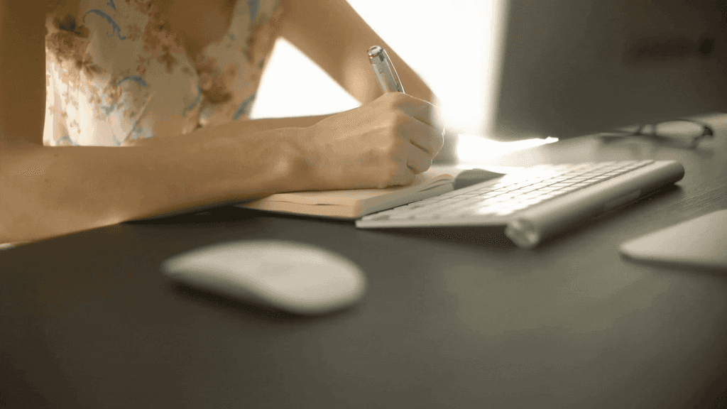 Filipina woman writing in her journal documenting her PCOS journey