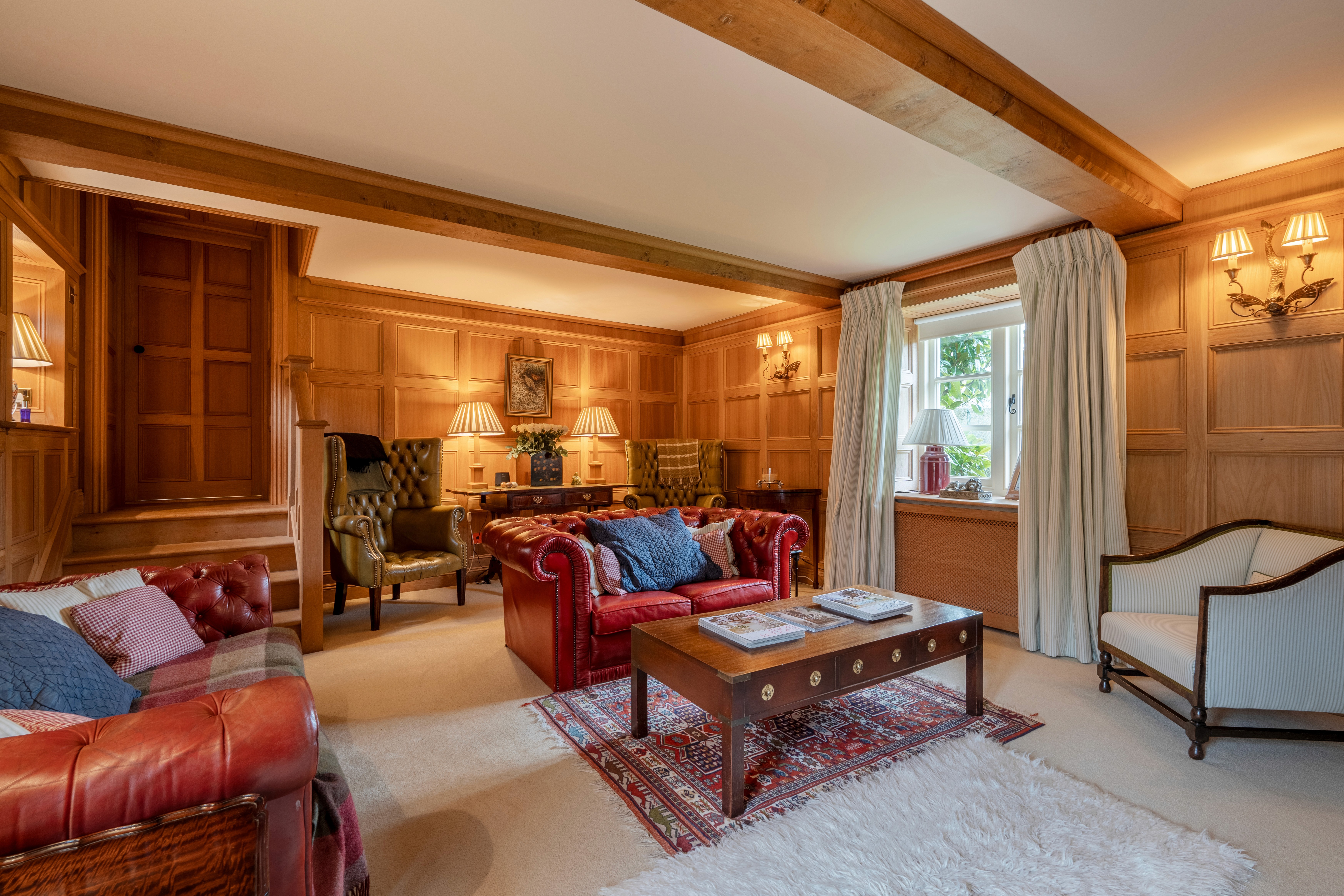 Sitting room with oak panelling and classic furniture