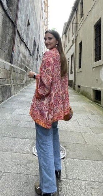 man sitting on gray concrete wall