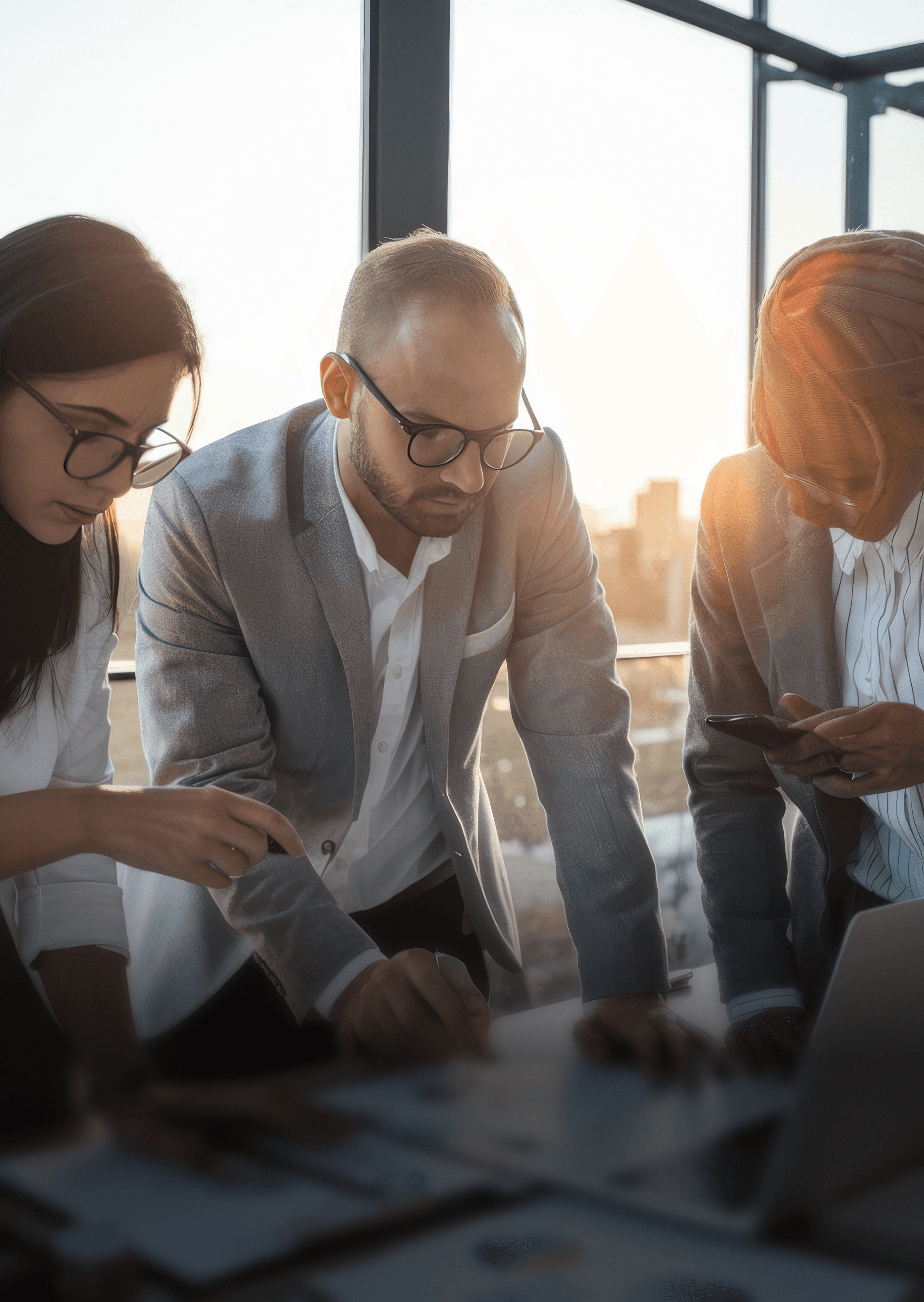 photo of three finance people gathered around a table 