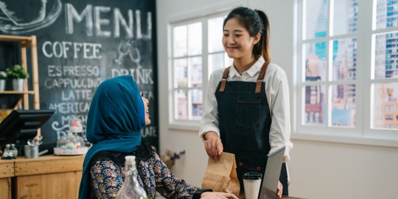 A F&B employee helping out a customer