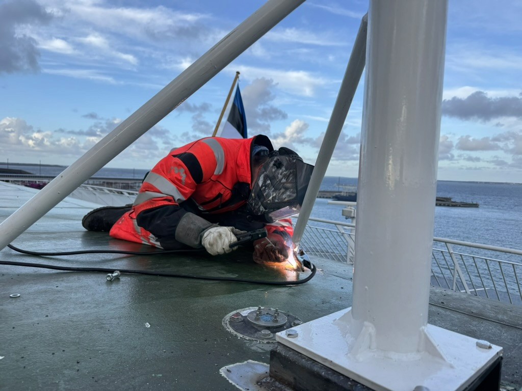 Technician welding during a marine infrastructure installation