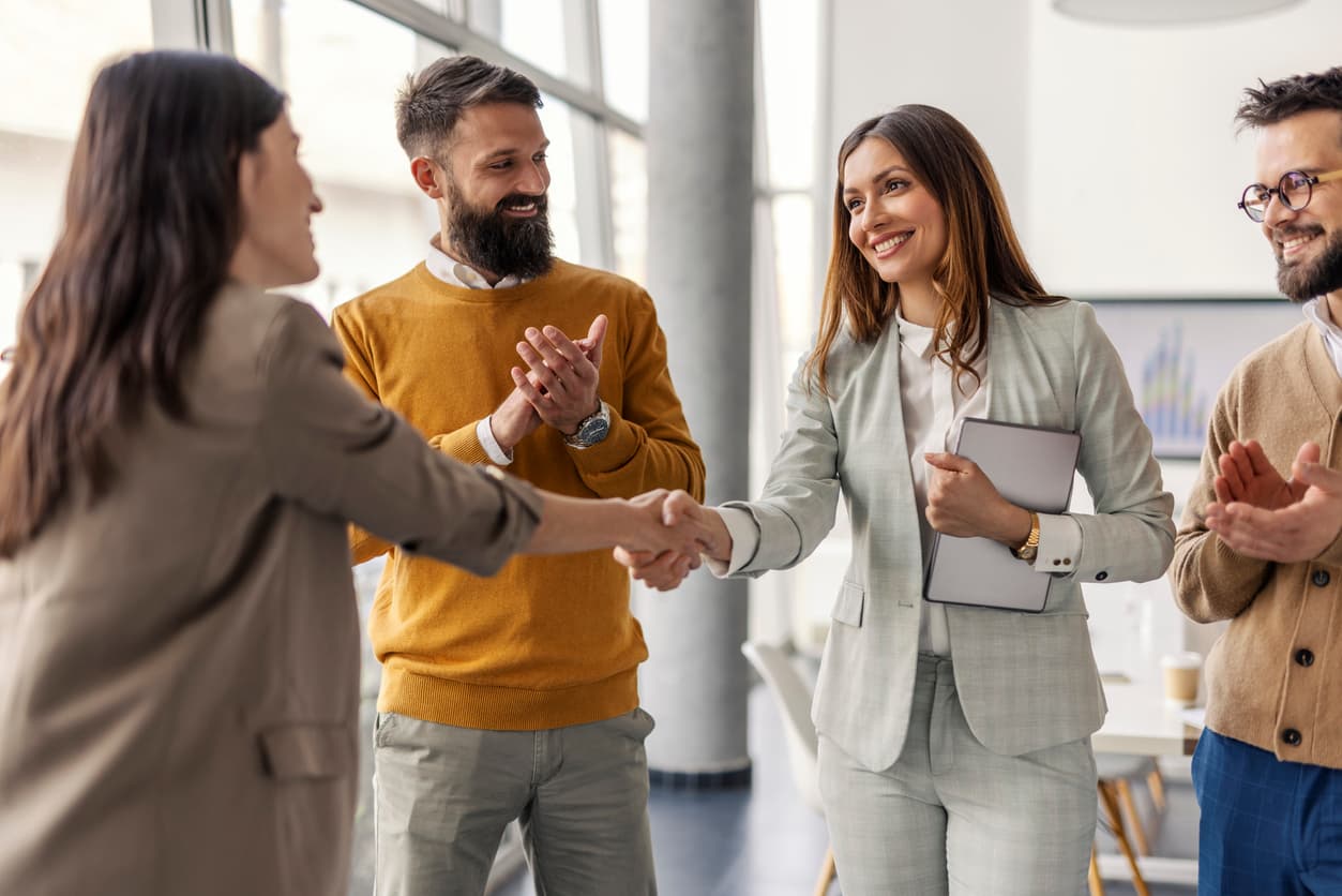 A group of people handshaking in an event