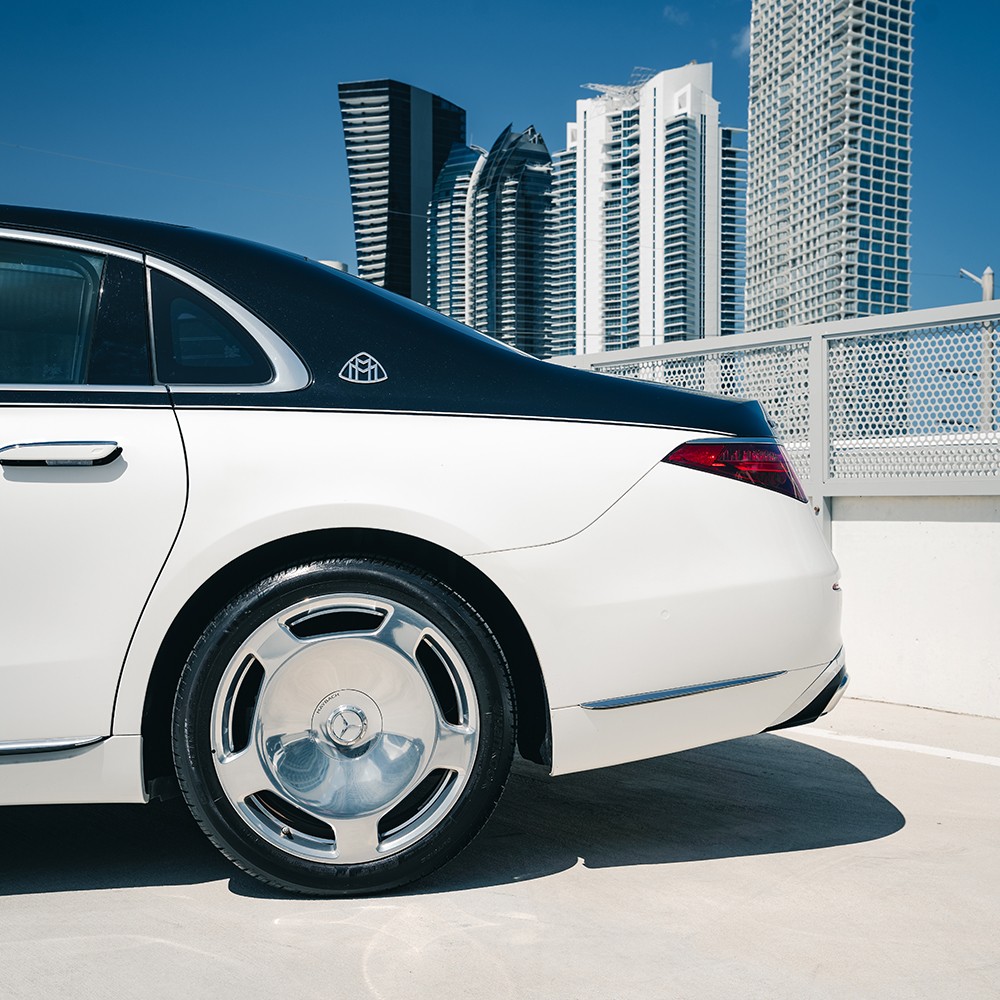 Close-up of the two-tone Mercedes-Maybach S580's multi-spoke wheel and Maybach badging on the C-pillar.