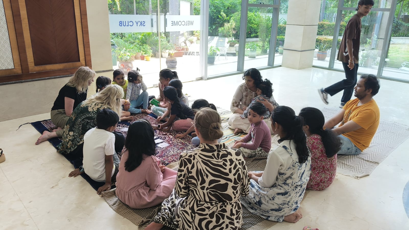 A teacher is explaining a topic to the class, speaking with gestures to emphasize points